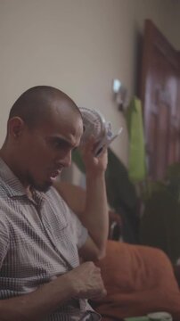 Frustrated man cooling off with small fan