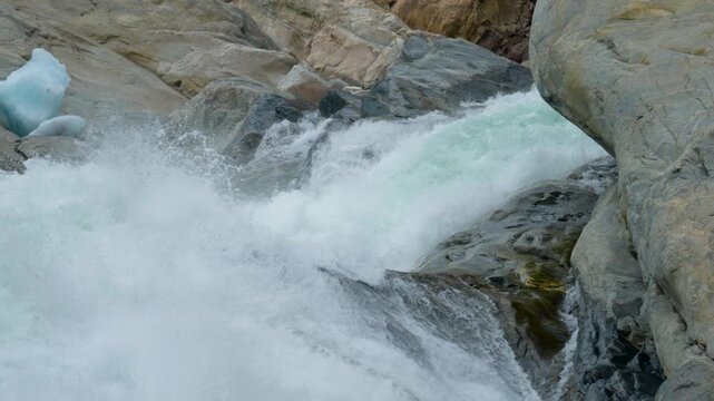Static shots of a powerful glacial meltwater river flowing from Nigardsbreen Glacier in Norway. Turquoise fragments of ice lie among the rocks as rapidly flowing water rushes through the rugged glacia