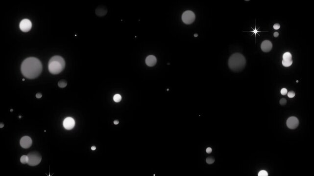 Particles of light drift slowly across a black void to represent a calm and meditative environment.
