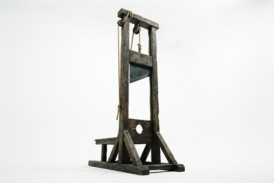 Antique wooden guillotine on white background