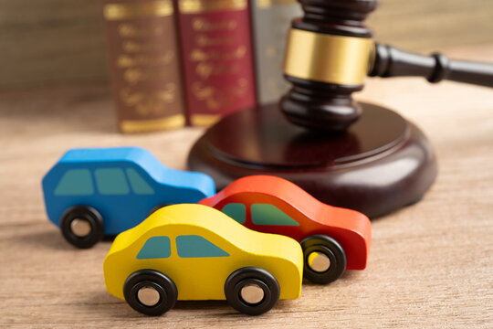 Hammer gavel judge with car vehicle accident, insurance coverage claim lawsuit court case.