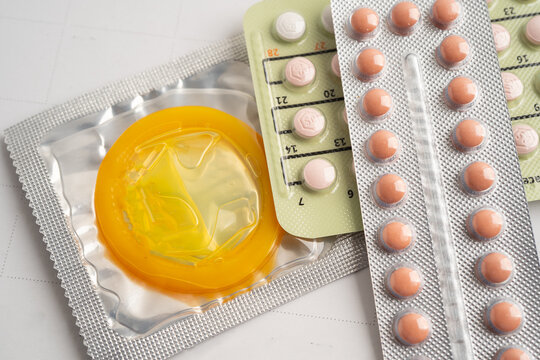 Pregnancy test and birth control pills on calendar, contraception health and medicine.