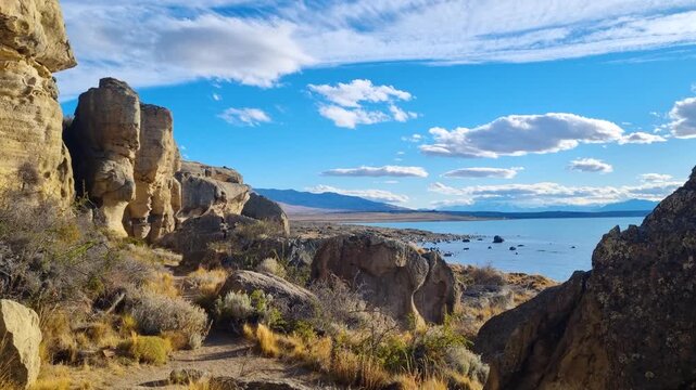 Scenic Punta Walichu coastline near El Calafate, Argentina, with glacial waters of Lago Argentino surrounding rocky Patagonian terrain under soft light, capturing the tranquility of the ancient park