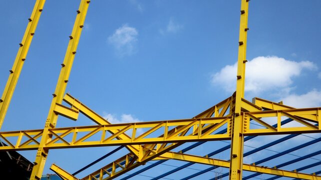 The yellow steel construction frame of the building
