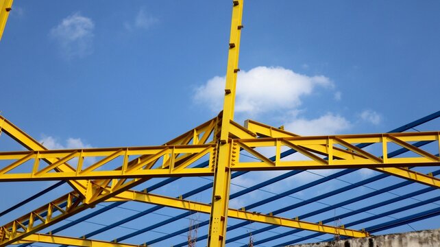The yellow steel construction frame of the building