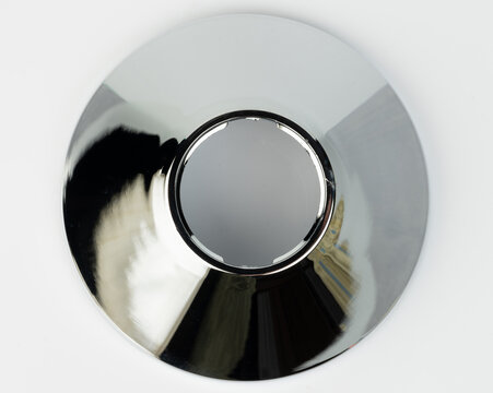 Shiny metal object with a circular shape and center hole