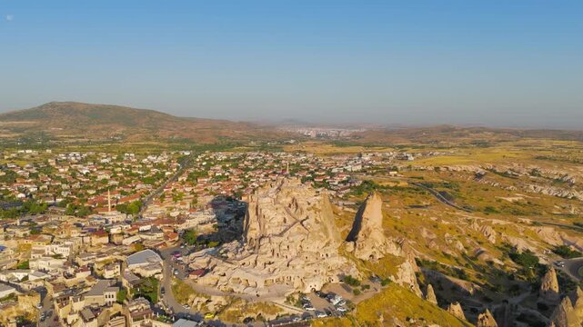 Uchisar, Nevsehir, Turkey. Uchisar Castle, a 60-meter rock citadel carved from volcanic tuff, aerial panoramic view in morning sunlight over the Cappadocian landscape. Aerial View, MasterShots, Circl