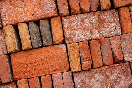 Texture of an old red brick wall with a weathered rustic surface, Vintage-style brick wall background with a natural rough texture, Red bricks.
