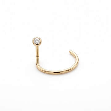 Gold nose ring with diamond accent isolated on white background  