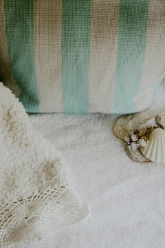 Spa background with decorative seashells and crocheted decorated towel, providing space for text for advertising or branding campaigns.