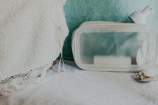 Travel bag with beauty products and toiletries for a relaxing spa day, promoting self care, wellness, and healthy skincare routine in a peaceful pastel setting