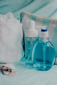 Spa relaxation scene featuring blue cosmetic bottles and white towels for skincare, self care, and wellness rituals, promoting a calm and peaceful experience