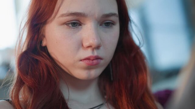 Closeup caucasian redhead reacting to prophecy and message, microexpressions show doubt and quiet sadness, student and seeker digest prediction, soft ambient light on freckled skin, cinematic shallow