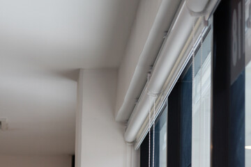 Obraz premium White roller blinds on large window