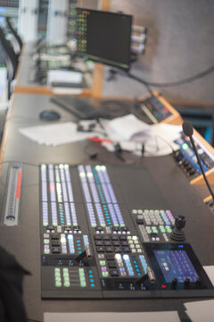 Professional television broadcast control room desk with video switcher and copy space