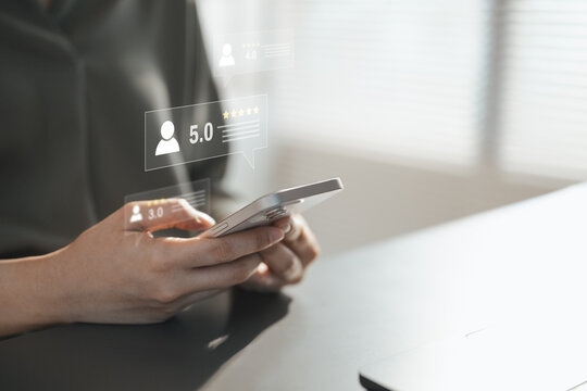 Customer giving a five-star review on a smartphone, representing satisfaction, feedback, service quality and online reputation.