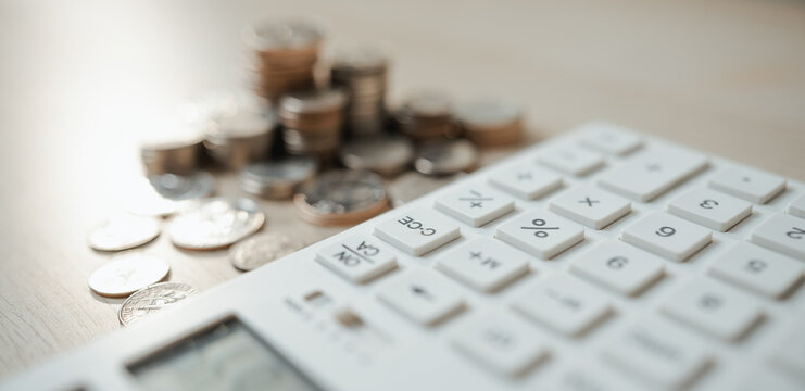 Calculator and coins illustrate interest rate comparison for savings, investments, and loans, supporting smarter financial decisions.