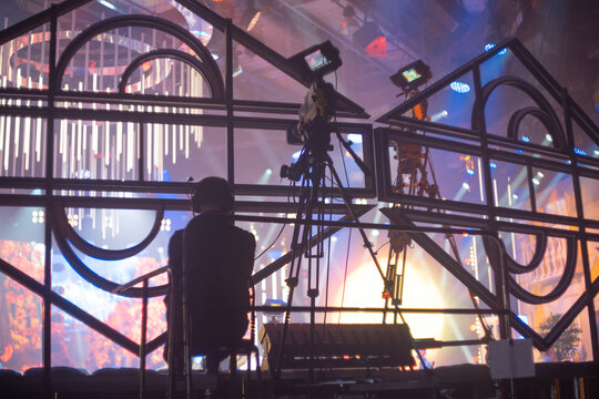  Professional camera crew filming live event on concert stage with copy space
