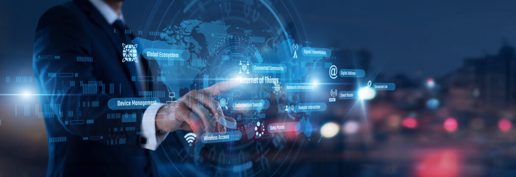 Connected devices. Developer hand touching Internet of Things words and icons on a smart board. Managing wireless sensor networks and all integrated hardware communications.