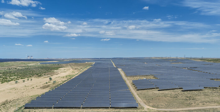 Aerial View of Vast Solar Panel Power Station in Desert