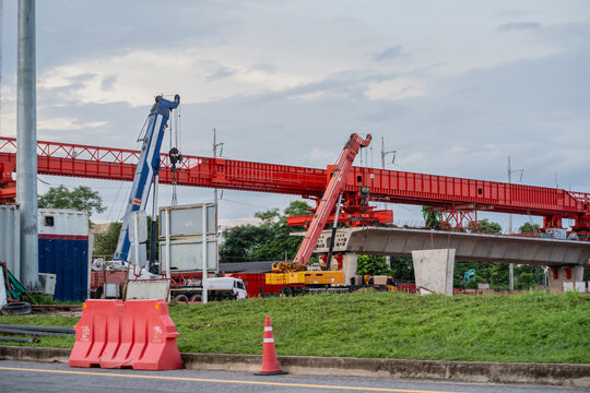 Backdrop of buildings at a construction site for new concrete roads and bridges represents urban development in transportation, a crucial infrastructure for a major city.