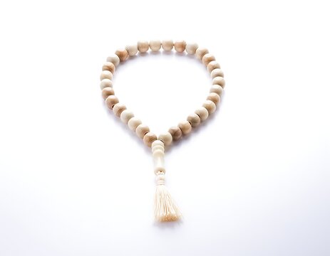 Close-up of delicate gold braided rope necklace with tassel.