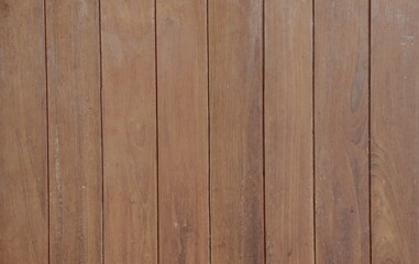 Fototapeta premium Natural vertical brown wooden plank texture background, seamless teak wood wall pattern for design and decoration.