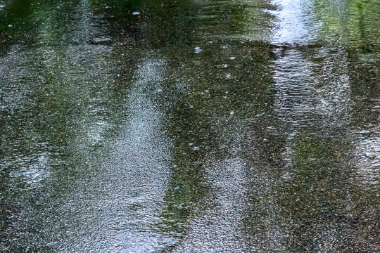 flooded city street after heavy rain. raindrops on wet asphalt.