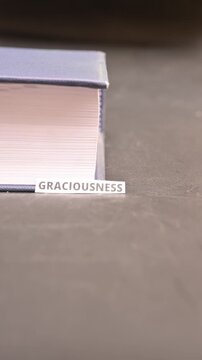 Graciousness Concept on Paper Bookmark Between Books Kindness Macro Video