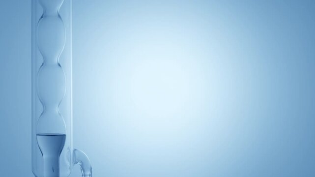 Transparent blue fluid filling up a vertically mounted bulb lab condenser on the left side of the frame, leaving the right side as copy space placed on a blue curved platform