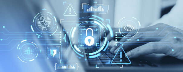 Fototapeta premium Digital lock and fingerprint icons overlay a laptop in a sleek blue graphic style on a blurred office background, symbolizing cybersecurity