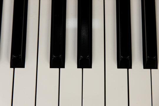 Close view of piano keys showing black and white pattern in a music room