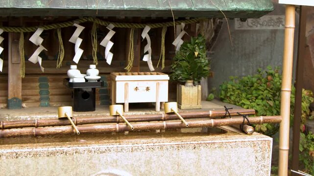 Traditional Shinto Shrine Chozuya Water Basin with Bamboo Ladles