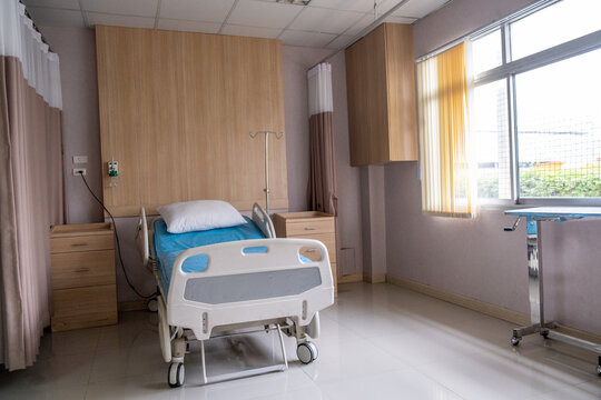 Hospital patient room bed, quiet clean medical ward with natural light