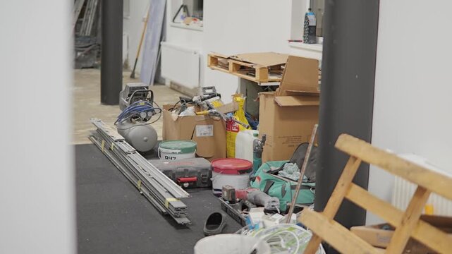Construction workspace filled with tools, materials and renovation supplies