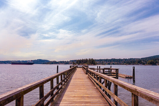 Belcarra public pier on a summer day in BC, Canada with view across Bedwell Bay to Deep Cove and Dollarton.