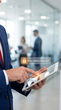Businessman in a navy suit using a tablet with a digital security lock and need admin approval text in a blurred office hallway setting