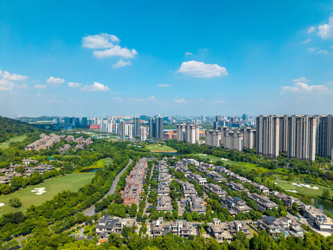 Aerial view of modern residential buildings and green urban landscapes in the Optics Valley development zone in Wuhan China under a clear blue sky