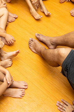 Group of children sitting on floor with adults during activity in a community space