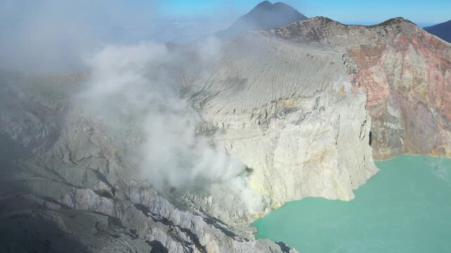Acidic sulfur lake, smoking crack of Ijen volcano on Java island, Indonesia.