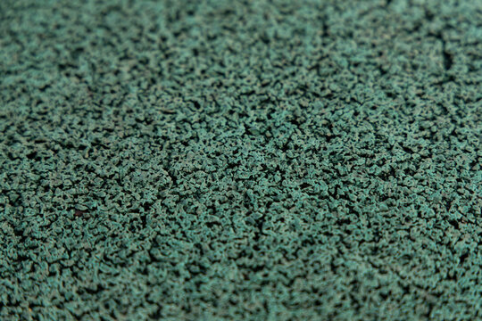 Green textured surface made from small particles in workshop setting