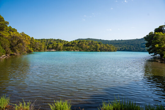 View of Malo Jezero or Small Lake in Mljet National Park on Mljet Island in Croatia. Protected Mediterranean nature and peaceful lake landscape concept.