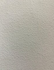 Fototapeta premium Full frame macro background texture of a rough white painted plaster wall surface.