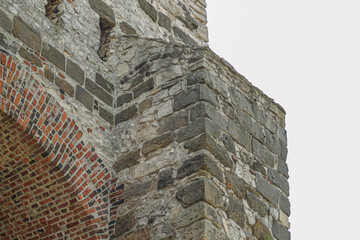Close-up of castle stone corner with red brick arch detailed real photography ancient reference © Artem