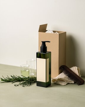 Green cosmetic pump bottle mockup with comb and craft box