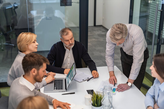 Business meeting - manager discussing work with his colleagues.