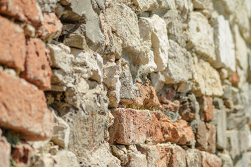 Obraz premium Close-up texture of weathered stone and red brick castle wall real photography