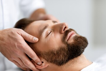 Fototapeta premium Physiotherapist performing cranial sacral therapy