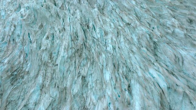 Aerial drone footage of the Nigardsbreen glacier, one of the glacier arms of the Jostedalsbreen ice cap in Norway. Various views show the blue-white glacier ice, crevasses, rocky surroundings and melt