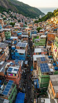 Solar panels on colorful favela rooftops generating renewable energy in Rio de Janeiro hillside community